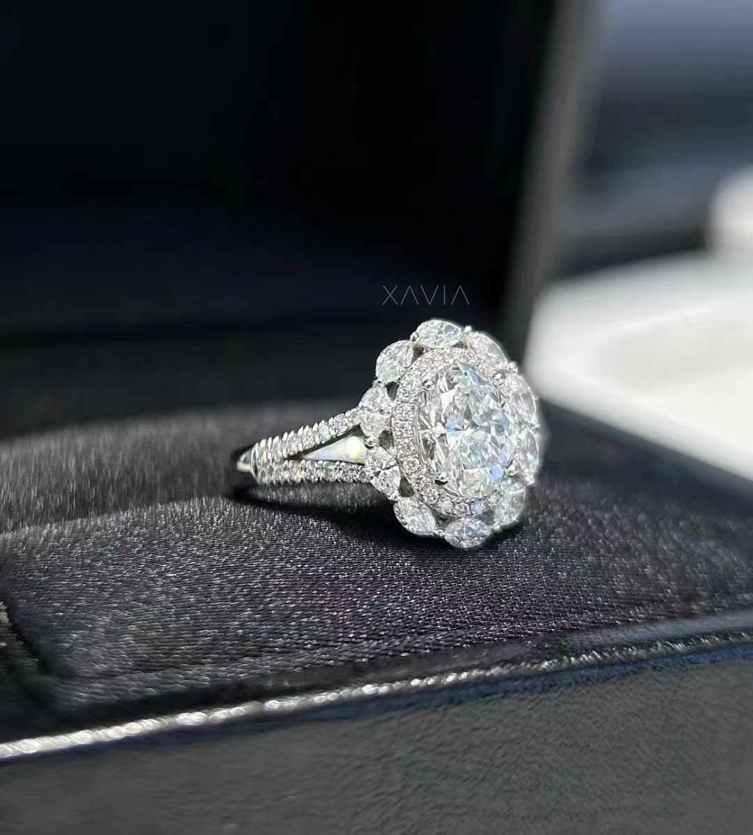 side profile of Lunessence oval diamond engagement ring featuring marquise floral halo cluster and pavé split shank band